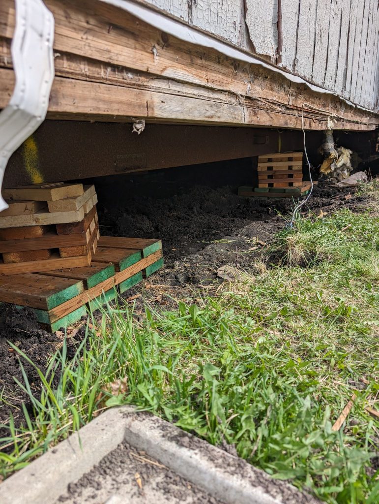 Mobile home lifted and levelled and sat on new pads and cribbing